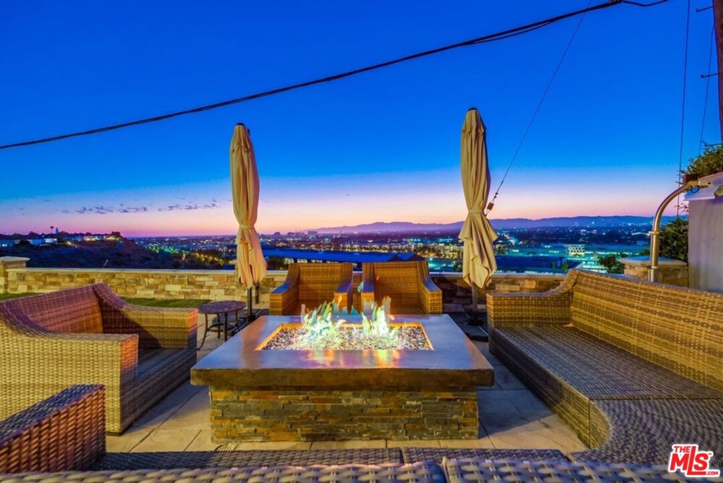 Nestled in a quiet cul-de-sac, this 5-bedroom, 4-bathroom stunner offers sweeping 180 viewsfrom the shimmering Pacific to the twinkling lights of Hollywood. Whether you're sipping coffee at sunrise or hosting sunset soires, the vistas are unforgettable.Inside, comfort meets style: Step inside the beautiful entrance and be greeted by a gourmet kitchen that effortlessly transitions into the dining and family areas, all offering a backdrop of unparalleled vistas that paint a picture of opulence and grandeur. The world unfolds before you as you explore the vast expanse of this amazing home. Venture upstairs to discover the lavish master suite complete with a spa-like bathroom and his and her closets, while two generously sized bedrooms share a tastefully appointed bath, and a private office. On the main level, an expansive extra room beckons, ready to be transformed into a playroom, a decadent movie theater, or any other lavish retreat your imagination can conjure. Thoughtful design touches abound with the inclusion of a powder room and a convenient laundry room for added ease and comfort. A secluded guest bedroom and bath offer privacy and comfort for visitors, ensuring that every guest feels welcomed and pampered. Outside, a well-appointed backyard provides ample space for sophisticated entertaining and al fresco dining.This home blends serenity with sophistication, perfect for families, entertainers, or anyone seeking a retreat above the city. With its prime location and thoughtful upgrades, it's more than a house it's a lifestyle.