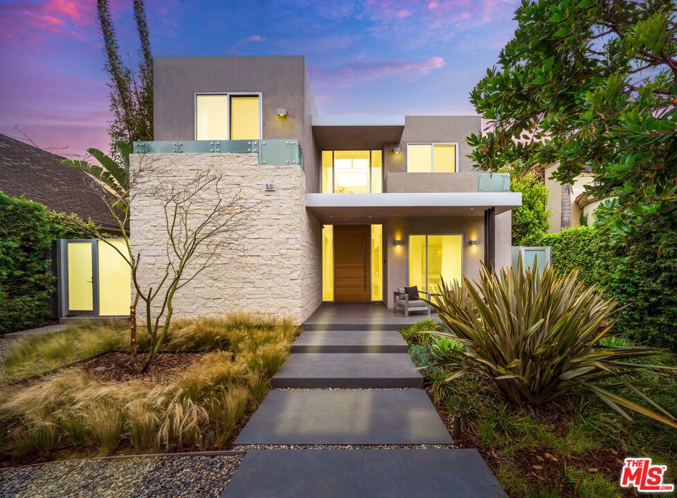 Spectacular modern masterpiece, set on one of the most coveted streets North of Montana. With no expenses spared, this bespoke home was the creation and vision of the current homeowner along with award winning architect Gabriel Sandoval. Completed in 2016, this 6,523 SF home with 6 en-suite bedrooms and 8 baths features the finest quality of construction with designer finishes at every turn. With warm earth tones, glass, stone and steel, this sleek home is the ultimate private oasis. Set on three levels, this home features state-of-the-art technology with an elevator that stops on all 3 floors, automated skylights with shades throughout, and a top-of-the-line smart house all controlled on an iPad/smartphone. Entertain flawlessly in the sleek modern kitchen lined with Miele appliances including a built -in Miele coffee station, custom modern cabinetry, and a center island. A large family room just off the kitchen all lead out to a covered patio with built-in grill, recessed heaters, and an outdoor fireplace, making this the perfect spot to enjoy all year long. Three en-suites upstairs including the primary suite that rivals any 5-star hotel with its large private deck, massive custom walk-in closet, fireplace and sitting area. The spa-like bath boasts an oversized shower/steam free standing soaking tub and dual vanities. The lower level completes this entertaining mecca with an amazing 7.1 surround sound cinema, chilled wine room for 300 bottles, kitchenette and 1 bed/1 bath. A detached two car garage, a separate 1 bed/1 bath guest suite with kitchenette, and side yard for a third car or a play area makes this the ultimate compound. Perfect for anyone with unparalleled taste looking for an elevated lifestyle, this is a rare opportunity to purchase one of the coolest homes in Santa Monica!