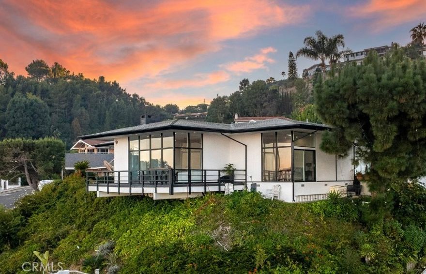 Positioned high above the street this Mid-Century Modern masterpiece sets the tone the moment you walk in… a wall of glass exposes the ocean and coastline, setting up the most memorable first impression. The open floor plan flows from entertaining area to the modern infused kitchen with soaring ceilings and equally impressive views. Nano doors open up to create an indoor-outdoor living experience with a deck and the most incredible pool with spa, waterfall, slide, ariel water and fire features complimented by an exotic custom lighting system to enhance the mood of any party. The master retreat is perfectly positioned to take in the amazing views and is complimented by its modern spa infused bathroom with modern soaking tub and separate shower. Additional features include wrap around viewing deck, custom lighting, remodeled bathrooms, and so much more. A completely private and secluded property within 6 minutes from the 110 freeway. Residents have access to the top-ranked Palos Verdes Schools such as Mira Catalina Elementary, Miraleste Intermediate, and your choice from two of the top ranked high schools in California. Minutes away, you can enjoy a game of golf or dine at Terranea Resort.