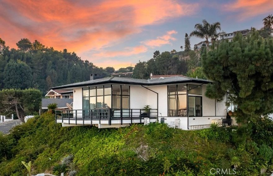 Positioned high above the street this Mid-Century Modern masterpiece sets the tone the moment you walk in… a wall of glass exposes the ocean and coastline, setting up the most memorable first impression. The open floor plan flows from entertaining area to the modern infused kitchen with soaring ceilings and equally impressive views. Nano doors open up to create an indoor-outdoor living experience with a deck and the most incredible pool with spa, waterfall, slide, ariel water and fire features complimented by an exotic custom lighting system to enhance the mood of any party. The master retreat is perfectly positioned to take in the amazing views and is complimented by its modern spa infused bathroom with modern soaking tub and separate shower. Additional features include wrap around viewing deck, custom lighting, remodeled bathrooms, and so much more. A completely private and secluded property within 6 minutes from the 110 freeway. Residents have access to the top-ranked Palos Verdes Schools such as Mira Catalina Elementary, Miraleste Intermediate, and your choice from two of the top ranked high schools in California. Minutes away, you can enjoy a game of golf or dine at Terranea Resort.