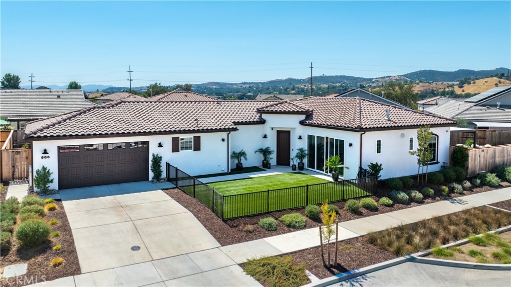 Welcome to Vintage, a highly sought-after 55+ community in the heart of Paso Robles wine country—where vibrant active-adult living meets relaxed luxury. At the heart of this home is a fully reimagined chef's kitchen - a complete redesign from the builder's original installation. Unlike what the builder offers as upgrades, this kitchen was completely reimagined with custom cabinetry, designer hardware, and professional-grade appliances, including a Viking cooktop, Viking double oven, Viking built-in drawer microwave, and an extended Calacatta quartz island with elegant waterfall edges. This one-of-a-kind space blends beauty and functionality in a way rarely available in the community. With over $255,000 in thoughtful upgrades, this residence was designed for both style and comfort. The open-plan living area captures both sunrises and sunsets filling the home with natural light throughout the day. The expansive backyard is professional landscaped to be eye-catching with low maintenance turf surrounded by palm trees, roses, and fruit trees. The living space outdoors features a louvered pergola with LED lighting and electric heaters for year-round enjoyment and BBQ. With one of the largest lots in the neighborhood, there's room for a lap pool, traditional pool, or your dream outdoor oasis. Additional enhancements include motorized Lutron Palladium shades, an epoxy-coated garage floor, a WaterMax softener with reverse osmosis filtration, a tankless water heater, and an owned solar system with Tesla Powerwall-delivering both luxury and long-term efficiency. Beyond the home, Vintage offers a true resort-style lifestyle. Residents enjoy lively block parties, BBQ's, and outings to Paso Robles' world-class wineries and restaurants. Future planned community amenities include a clubhouse, swimming pool, pickleball courts and bocce ball courts...just steps from your front door. Enjoy the convenience of River Oaks Golf Course and The Spirit of Paso Robles Restaurant just across the street, with the serene River Oaks Spa located right at the end of the road. This home is turnkey--luxury without the wait of new construction. Schedule your private showing today and discover why this residence sets a new standard for elevated living in Paso Robles wine country.