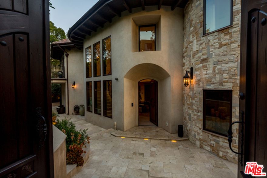 Stunning gated Tuscan Villa in prestigious Bel-Air.Panoramic views that offer an airy, bright & tranquil setting. The grand foyer w/ limestone floors throughout the home. Living room offers a grand space that leads to a grand terrace. The kitchen w/ hand painted tile back splash has antiqued cabinetry, walk in pantry, center island, dining area & bi-fold doors that lead to a terrace that offers a built in BBQ w/ a custom hood, beverage cooler & bar area.Master Bedroom suite w/ lrg sitting area overlooking views. Before getting to the master bath w/ the pedestal tub & lrg steam shower, you step into a hand built walk in closet. There are 3 other bedrooms on this floor, one is turned into an office. Downstairs has family room w/ indoor/outdoor living space, leading to a lap pool surrounded by cascading fountains. Game room w/ full bar, maid's room, guest suite w/ prvt entry, lrg laundry room & 2 bonus rooms. Smart home w/ controls 4, indoor/outdoor speakers, alarm system & elevator.