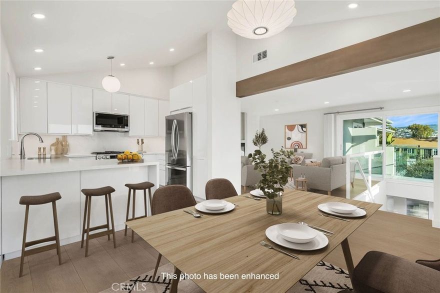 BE THE FIRST TO LIVE IN THIS BEAUTIFULLY REMODELED UPPER-LEVEL 2 BEDROOM 2 BATHROOM HOME IN NORTH LAGUNA.  Completely upgraded throughout, this light filled residence features raised ceilings, recessed lighting, new wide plank white oak high-end LVP flooring, and a modern gas fireplace.  Air conditioning in the living room ensures year round comfort.  The brand new kitchen includes Quartz countertops, stainless steel appliances, and custom cabinetry for maximum storage.  The living room opens to a private deck with ocean and sunset views, perfect for morning coffee or evening relaxation.  Both bathrooms have been remodeled with new cabinetry, fixtures, and countertops; the primary suite bathroom offers dual sinks.  A dedicated built in desk provides an ideal work from home opportunity.  Additional highlights include all new doors and windows, plus an oversized 2 car garage with epoxy flooring, extensive built in storage and washer dryer hookups.  The garage can accommodate two cars and can also be used as an art/creative studio space..  There are an additional two off street parking spaces behind the garage as well.   Located in a quiet tri-plex on a serene non-through street, the home enjoys minimal summer traffic yet is an easy walk to the beach and Heisler Park  The home is just far enough from the Coast Hwy to avoid noise, while still offering walkable access to North Laguna's beaches, galleries, and restaurants.  The lush shared garden provides seating for a peaceful outdoor retreat.  THIS IS A RARE OPPORTUNITY TO BE THE FIRST TO ENJOY THIS HIGHLY UPGRADED NORTH LAGUNA GEM!