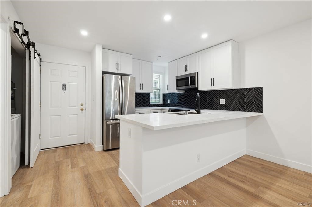 Limited-Time Offer: Get 1 Month Free When You Sign a 12-Month Lease! 1-Bedroom Apartment with Private Balcony in Prime Encino Location. This thoughtfully updated 1-bedroom, 1-bathroom residence offers comfort, style, and convenience perfect for individuals seeking a well-appointed home in a prime Encino location.Key Features: Open layout with hardwood floors. Private balcony ideal for relaxing after work or enjoying your morning coffee. Sleek kitchen equipped with LG stainless steel appliances and ample storage. Updated bathroom with modern fixtures and clean design In-unit washer and dryer for maximum convenience. Walk in closet and new ac units. Secure, gated parking available. High-speed internet ready perfect for remote work or streaming. Community & Location: Access to a sparkling pool and Pet-friendly. Walk to Ventura Blvd's top restaurants, cafes, and boutique fitness studios. Close proximity to Lake Balboa Park and Woodley Lakes Golf Course great for outdoor activities. Easy access to the 101 Freeway, making commuting to Sherman Oaks, Studio City, and West L.A. simple and quick. Located in a highly rated school district and near major hospitals and business centers.
