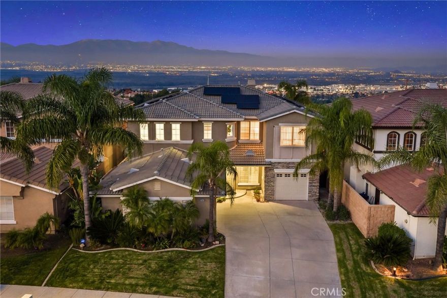 Perched in the scenic enclave of Sierra Del Oro, bordering Yorba Linda, this Mediterranean-inspired pool home captures breathtaking panoramic views of the San Gabriel and San Bernardino Mountains—including Mt. Baldy—and a glittering tapestry of city lights below. Perfectly positioned on a tranquil cul-de-sac with no homes behind, this 4-bedroom, 3-bath residence with a loft offers a rare blend of privacy, sophistication, and resort-style living. Inside, a grand foyer opens to soaring two-story ceilings and floor-to-ceiling windows that flood the living and dining areas with natural light, creating an effortless indoor-outdoor flow. Tile floors encompass the entire house, including brand-new floors upstairs. The chef’s kitchen, designed for both beauty and function, showcases gleaming granite countertops with a full backsplash, stainless steel appliances including a refrigerator, a waterfall island with bar seating, and a generous walk-in pantry—all seamlessly connected to the inviting family room anchored by a striking fireplace and expansive views. A main-level bedroom and a fully remodeled bath serve as a versatile retreat for guests or a home office. Upstairs, the primary suite serves as a private sanctuary with no neighbors in sight—only endless views of city lights stretching for miles. The spa-inspired bath features a freestanding soaking tub, a walk-in shower, and a custom-organized walk-in closet. Step onto the private balcony at sunset to enjoy the cool breeze and sweeping vistas. Two additional bedrooms and a spacious loft complete the upper level. Outdoors, the resort ambiance continues with a sparkling rock pool and spa, framed by dramatic views of the mountains and the city. Modern conveniences include a fully owned 46-panel solar system, water softener and filtration systems, and a split 3-car garage with built-in storage and direct access. Perfectly positioned just off the first traffic light leading to the 91 Freeway, this home offers unparalleled convenience—with swift connections to Orange County, the 91 express lanes, the 241 Toll Road, the Metrolink, and the scenic Skyline Trails for outdoor adventure. A rare fusion of elegance, privacy, and natural beauty—this exceptional home offers an elevated lifestyle in one of Sierra Del Oro’s most captivating settings.