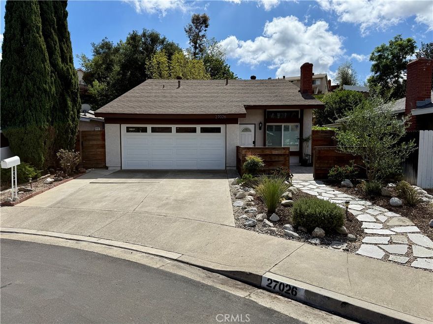 Welcome to this move-in ready 4 bedroom home located on a quiet cul-de-sac! This light and bright residence features an open floor plan with vaulted ceilings, a cozy fireplace, and a center-island kitchen with breakfast bar, stainless steel appliances, gas stove, and recessed lighting. One large downstairs bedroom with adjacent bath offers flexibility as a guest suite, office, or second primary—perfect for multi-generational living. Upstairs, the spacious primary suite includes a walk-in closet and direct bath access, with two additional bedrooms filled with natural light.



Recent upgrades include a brand new A/C, a whole house fan, new water softener, Nest thermostat, new blinds and shades, wood-look laminate flooring downstairs with neutral carpet upstairs, epoxy garage flooring with above-garage storage, and washer, dryer, and new LG refrigerator.



The entertainer’s backyard has been newly hardscaped and showcases a pergola with ceiling fans, outdoor sink, refrigerator, built-in gas grill, fire pit, and new citrus trees. This home also includes membership to Lake Mission Viejo for swimming, boating, fishing, concerts, and more. Conveniently located just steps from Barcelona Park and around the corner from Oxford Preparatory Academy.