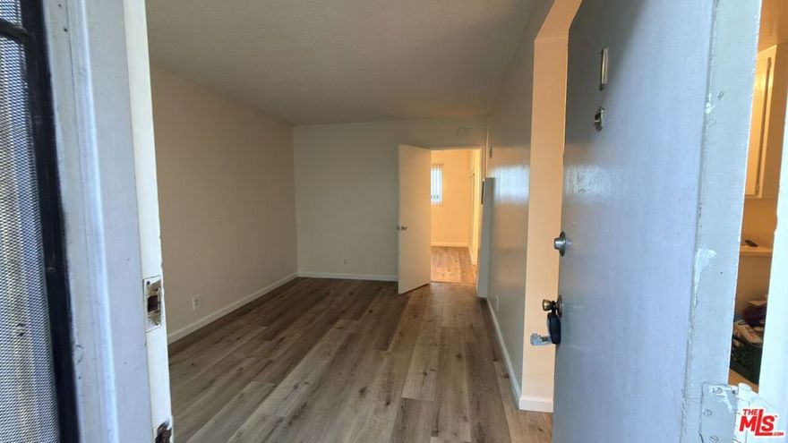 Conveniently located 526 sq. ft. ground-floor one-bedroom apartment with direct access from a key entry gated courtyard. The unit features hard flooring throughout and a functional, basic kitchen layout. Located in a fourplex, this apartment includes community laundry and a private, detached one-car garage. Tenant pays utilities. 12-month lease minimum. Security deposit equal to one month's rent. A centrally located housing option with easy access to local services, shopping, transit, and area amenities, including proximity to California State University, Long Beach.