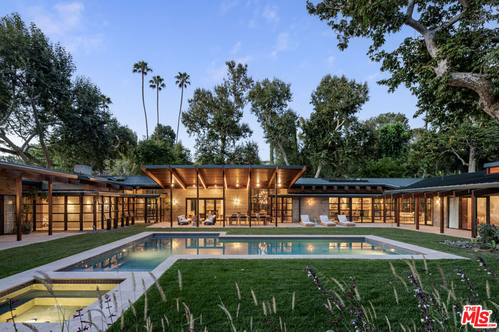 The Sherman Residence designed by famed architect Peter Tolkin sits on 3.26 acres south of Ventura BLVD. The house is made up of a series of board-formed concrete, wood and glass pavilions connected by gallery spaces that together define a central courtyard. The indigenous trees and working plants consisting of Sycamores, orange, avocado, palm trees and succulents can be seen from every room. Multiple structures including the main residence, guest house, gym and offices intentionally placed in this enchanting setting for privacy and views. An over sized north south tennis court with viewing deck is tucked atop the property. Once in a lifetime opportunity to own this exceptional estate.