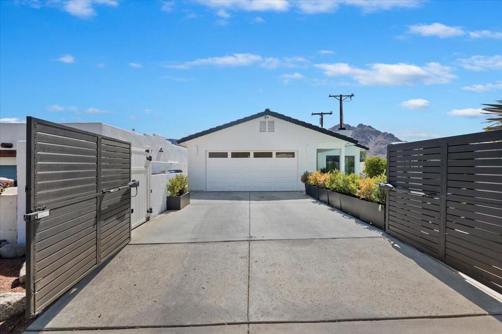 Located on an elevated corner lot in the sought-after La Quinta Cove, this beautifully maintained home offers a unique blend of style, comfort, and natural surroundings. Just steps from scenic hiking trails, the property captures impressive mountain vistas and a sense of peaceful seclusion. Inside, you'll find a light-filled, open floor plan that promotes easy living and entertaining. The living area features a sleek fireplace and flows effortlessly into a well-defined dining space, perfect for both casual meals and special occasions. The kitchen is thoughtfully designed with quality appliances, ample counter space, and a large island that serves as the heart of the home. The primary bedroom suite is a private retreat, complete with outdoor access and a peaceful sitting nook. The ensuite bathroom includes a spacious walk-in shower, double vanities, and plenty of storage. Outdoor living is equally inviting with several patio areas designed for lounging, dining, and entertaining under the stars. A covered section provides shade and comfort for year-round use. Additional features include updated HVAC systems for energy-efficient comfort. Whether you're looking for a tranquil escape or a stylish space to host, this home captures the best of desert living.