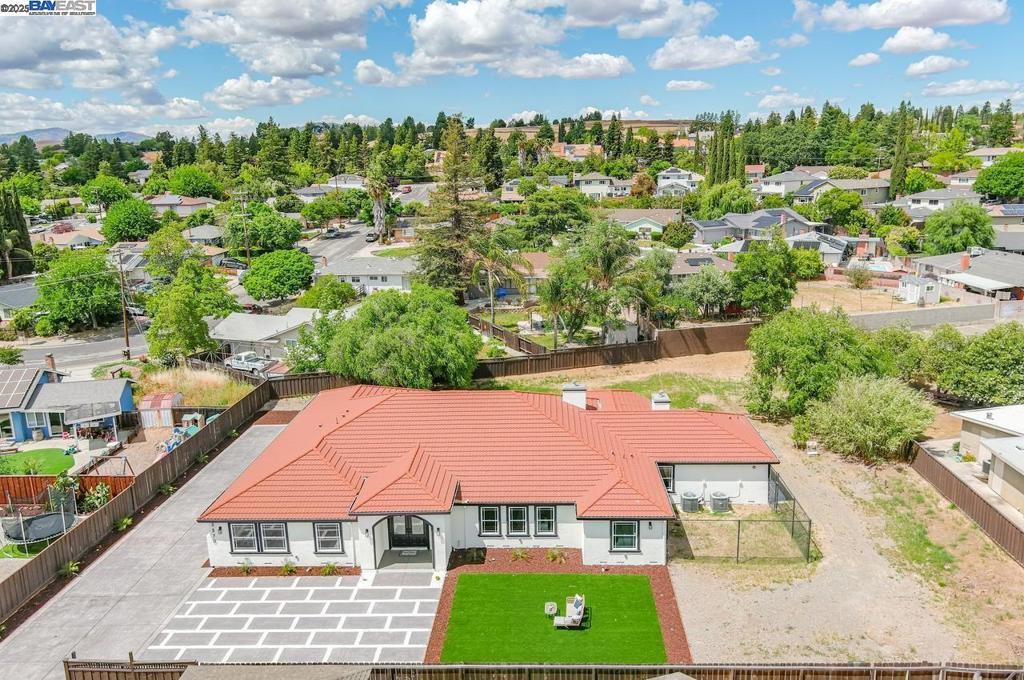 Fully remodeled. Private location on a flat 1/2 acre lot, 3-car + finished garage with a new and convenient additional paved driveway ample enough for 8 parked cars! Plenty of room for other vehicles/boats/RV! This is an amazing and spectacular single level, includes 5 separate bedrooms and a dedicated office, laundry room, and separate utility room. This incredible home offers a rare blend of luxury and functionality. Inside, the open-concept layout features upgrades throughout! Expansive game room area. Massive kitchen and island is a chef’s dream with commercial/quality style fridge, bar-top seating, stainless appliances, and space for a dinette. 6-burner gas stove and double ovens! Upgrades include travertine tile entry and halls, and luxury plank flooring, crown molding, and recessed lighting throughout. Luxurious main suite is a retreat of its own, showcasing a double-sided fireplace, lounge area, jetted soaking tub, tiled shower, dual vanities with lighted mirrors, and a huge walk-in closet. The backyard is expansive and ready for your dream design. Lot has entry gate on remote. See City of Livermore for zoning and allowable uses. Lot is fully fenced with front gate and sits at the end of easement road connecting adjacent property owners. Rare opportunity —