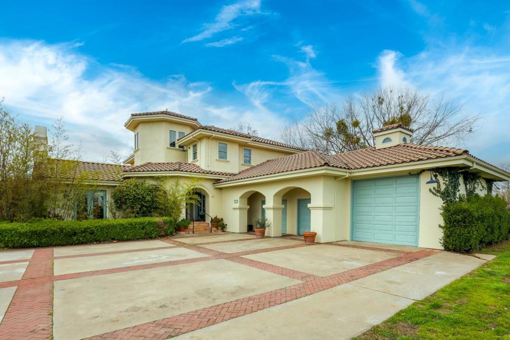 Welcome to this spacious and charming two-story ranch home located in the rolling hills of Clements! This home offers 3,985 square feet of living space with four bedrooms and three full bathrooms. The well-appointed kitchen is a chef's delight, featuring granite countertops, top-of-the-line appliances ensuring a seamless culinary experience. The interior boasts elegant hardwood and tile flooring, complementing the inviting "country living" ambiance. Warm up by the one of the cozy fireplaces during cooler evenings, adding a touch of comfort to your gatherings or relax pondside with a glass of Lodi region wine and let your worries melt away. The primary suite balcony offers stunning views of the adjacent hills and vineyards. An 8-stall barn will satisfy the needs of even the seasoned equestrian. The property includes forced warm air and central AC ensuring year-round comfort. Residents benefit from the Lodi Unified School District, providing educational opportunities for students at any age level. Additional amenities include a three-car garage with a workshop area and solar panels. Experience the charm of country living in the hills of Clements!