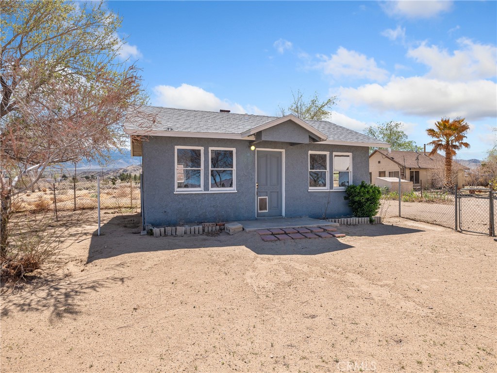 THREE HOMES on 10 acres! Each home has its own electric meter, the convenience of natural gas in two of the homes and propane in the other. All three homes are served with water from the well, eliminating water bills! Located on a PAVED road, the main home is 962 sf and features two bedrooms and one bath. The front home is 550 sf and has one bedroom and a bath. The 3rd home on the property has 692 sf and one spacious bedroom and one bath.
There is a large barn with a single-car garage attached and an additional building you could use as a shop and extra storage.
The land features mature shade trees and desert landscaping with ample space to establish an orchard or garden. Bring your horses here! There is plenty of room for your horses and all your livestock.
This property provides flexibility for multigenerational living, rental income, or personal use. The possibilities are endless!
The location of this multi-dwelling residence is in a peaceful, rural setting yet only minutes away from local amenities. Big Bear Lake is just a 30- minute drive from here. Come check it out!