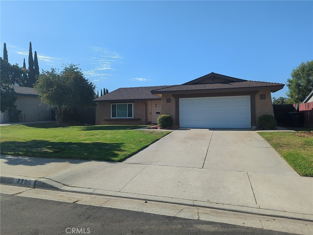Beautiful home with no neighbors behind you! This single story home is in a great location with quick/easy freeway access. You step into a large and open living room and formal dining area. Family room with fireplace off of the kitchen that features appliances and solid surface counters. There is also additional cabinetry. Fresh interior paint throughout the home in neutral color palette; luxury vinyl plank and tile floors; light fixtures all give this home a nice update. Dual pane vinyl windows and ceiling fans throughout will keep you cool and utility costs low. Covered patio and several citrus trees in the back yard. Laundry in garage. One year lease. Pets okay with additional monthly pet rent; breed restrictions apply and must provide proof of registration/shots up to date.