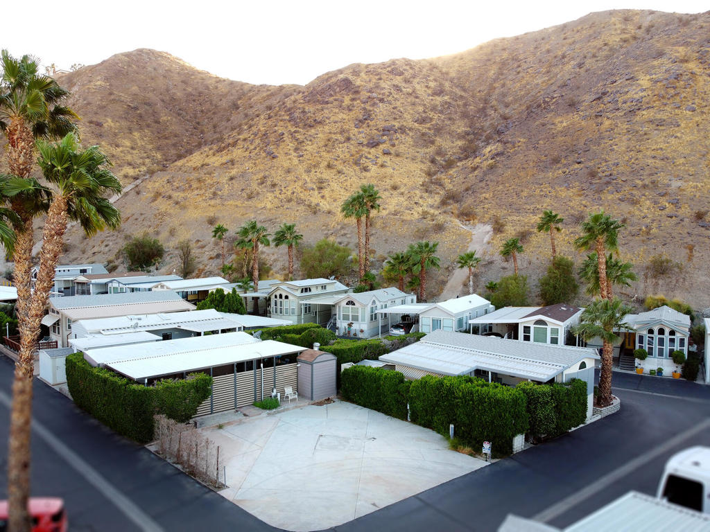 This lot is situated at the top of the Sungate community at the base of the desert mountains, offering great views. Conveniently located across from the Clubhouse, this vibrant community boasts a wealth of amenities, featuring two heated pools, three spas, along with a game room and weekly activities. Designed for a quiet, enjoyable lifestyle, this 55+ gated community is perfect for those seeking relaxation and recreation. The lot is ideally positioned next to the Clubhouse for added convenience. For those who prefer more luxurious options, the lot is located near Palm Springs and The River outdoor mall in Rancho Mirage, and is walking distance to a variety of restaurants, including Agua Caliente Casino.