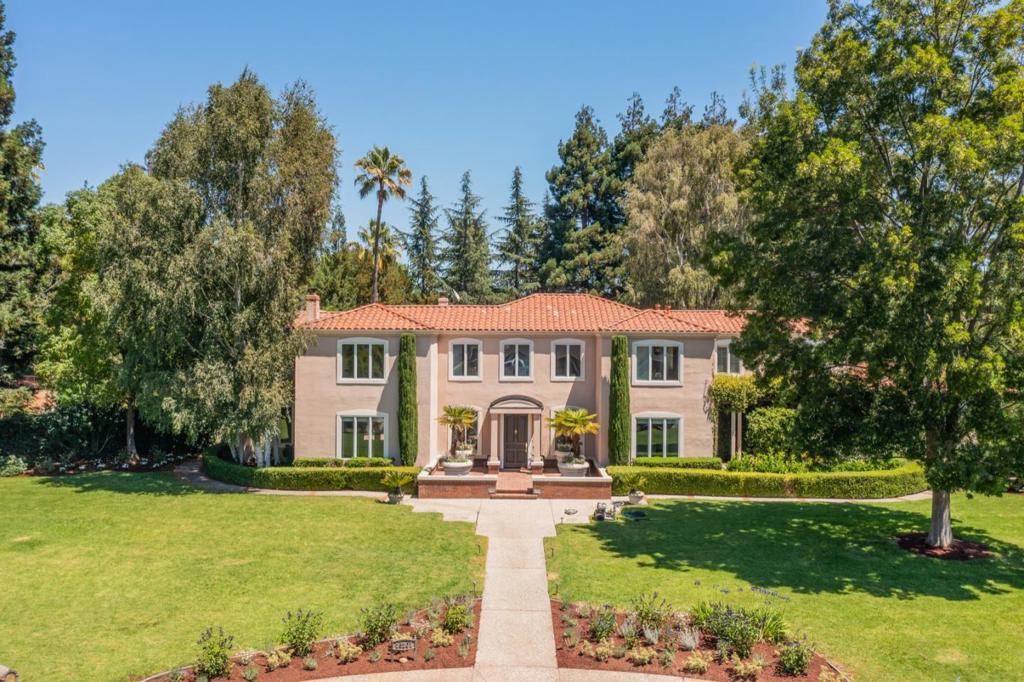 Classic and timeless, and beautiful inside and out, this stately home is ever-so-spacious surrounded by gorgeous grounds. The vast level land at the end of a cul-de-sac is just over one mile from the Village for close-in convenience. Hardwood floors, plantation shutters, and crown moldings are found in many rooms, the kitchen is beautifully updated in a black and white palette with high-end stainless steel appliances, and formal venues await entertaining on a grand scale. A dedicated office for today's work-from-home needs. A pool house with full kitchen and bath adds to the accommodations on the vast rear grounds with pool, spa, and level land for play and entertaining - all in complete privacy. Adding the finishing touch is access to excellent Los Altos schools.