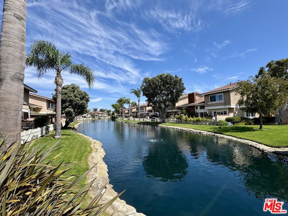 Welcome to this beautifully remodeled 3-bedroom, 2.5-bathroom two-story townhome at the end of cul-de-sac in the highly sought-after gated community of Seaside Village in Huntington Beach. With the feel of a single-family home, this bright and spacious residence offers an open floor plan filled with natural light, soaring vaulted ceilings, and tasteful modern upgrades throughout. The remodeled kitchen features quartz countertops, sleek cabinetry, and flows seamlessly into the dining and living areas. Enjoy the warmth of the gas fireplace in the living room or step outside to your expansive private patio overlooking a tranquil lagoon perfect for relaxing or entertaining. Upstairs, the primary suite boasts a large walk-in closet and a luxurious en-suite bath with dual vanities. Two additional bedrooms are generously sized with ample closet space. Additional highlights include new luxury wide-plank laminate flooring, remodeled bathrooms, recessed lighting, fresh paint throughout, private 2-car direct access garage with a full-size washer and dryer. Seaside Village offers resort-style amenities including a clubhouse, pool, spa, tennis and basketball courts, dog park, and scenic lagoons where you'll often see ducks and ducklings, are ideal for fishing, kayaking, and bird watching. Community events foster a welcoming neighborhood vibe. The location is unbeatable just a short walk to Surf City's world-famous beaches, Huntington Beach Pier, Main Street shopping and dining, Manning Park with playgrounds and picnic areas. The Bolsa Chica Ecological Reserve with hiking trails is just a short drive away. All this plus being in an excellent school district makes this home an incredible opportunity. INTERIOR PHOTOS COMING SOON