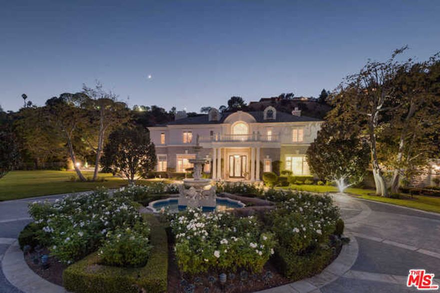 Behind gates and up a long private driveway in the guard-gated community of Beverly Park, lies this over-5 acre Traditional Estate surrounded by sprawling lawns and mature landscaping. Inside, a formal entryway boasts 40 ft ceilings, crown moldings and dual powder rooms. Retreat to a 2-story library or entertain guests in the grand formal dining and living rooms. With over 20,000 sf, the property features a Master with dual closets/baths plus 6 additional en suite bedrooms up. Downstairs, a guest room is separate from 2 staff rooms. A third level is a perfect bonus space for a playroom, gym, guest quarters, or storage. With canyon views and a ton of natural light, this home also features floor- to-ceiling french doors and timeless marbles and finishes. With an abundance of land this property also has a tennis court, mosaic pool and spa, plenty of outdoor entertainment space, custom playground, gazebo, park-like trails, and 2 separate garages with covered parking for 5+ cars. Must see.