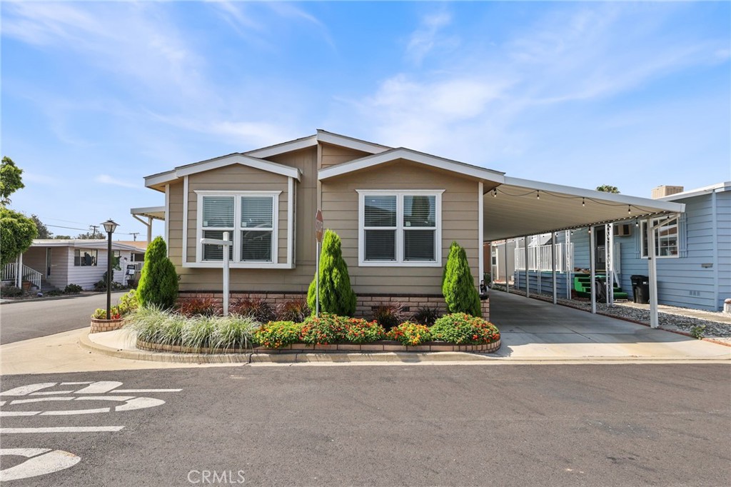 Gorgeous Turn-Key Newer 3bedroom 2bath- Ready to Move In!! This 'Like-New' home has an Open Floor Plan that is light and bright and feels spacious. Located in an All-Age Community in the City of La Verne featuring a Great School District and tons of activities for All Ages. This home has upgraded features including laminate wood flooring and drywall throughout with brushed nickel fixtures and accents. Island Kitchen with Sink saves space and features tons of counter and cabinet space, complete with a Skylight! This home features recessed lighting and ceiling fans throughout. All bedrooms are spacious and can easily accommodate your furnishing needs. Master bedroom features master suite bathroom complete with walk -in shower and separate Glamour Tub. This beautiful home is located on a corner lot and features a large shaded front porch and long driveway that can easily accommodate 3 car parking. Complete with a storage shed for your storage needs and an irrigation system to maintain the low-maintenance landscaping makes this home a great choice if you are looking for a turn-key move in ready home. All Age Community just underwent a 3Mil renovation including new streets and updated facilities for the resident's use and enjoyment. Community features a pool, playground, 2 green belts, dog walking area, RV storage, clubhouse/banquet room with kitchen and billiards, indoor jacuzzi and library and tons of guest parking throughout. The surrounding City of La Verne also offers tons of Entertainment, Activites, and Restaurants for your Enjoyment.