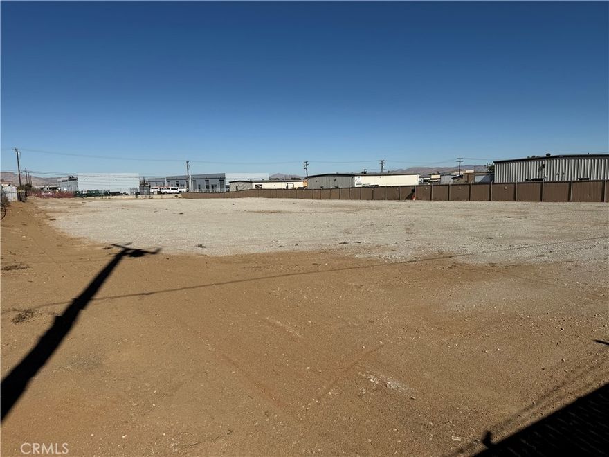 Vacant Commercial lot in Hesperia Industrial area. 1.3 Acre. Commercial fencing installed. Lot graded with class 2 base rock. Owner has street improvement plans. Off I Ave. on Catalpa.