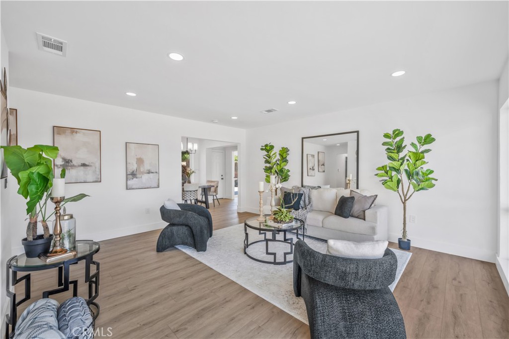 Step into this freshly reimagined Highland home. A modern-meets-midcentury retreat with thoughtful details at every turn. Inside, sunlight streams through oversized picture windows, highlighting warm wood-look floors and an airy, open layout designed for both daily living and stylish entertaining. The kitchen makes a statement with gleaming quartz counters, subway tile backsplash, and soft-close shaker cabinetry, all anchored by sleek black hardware and stainless appliances. Both bathrooms are magazine-worthy: one wrapped in serene sage-green tile with matte black fixtures, the other accented with soft neutral tones and brushed gold hardware. Behind the scenes, major upgrades like a full repipe, dual-pane windows, and a new electrical panel provide peace of mind for years to come. The spacious backyard is a blank canvas under mature shade trees, perfect for a future pool, patio, or garden oasis. Out front, a low-maintenance desert landscape frames the home’s clean, modern lines. Set on a quiet street close to local schools, shops, and the San Bernardino Mountains, this home is ready to be the backdrop for morning coffee by the picture windows, backyard barbecues under the shade trees, and years of memories in a thoughtfully updated space.