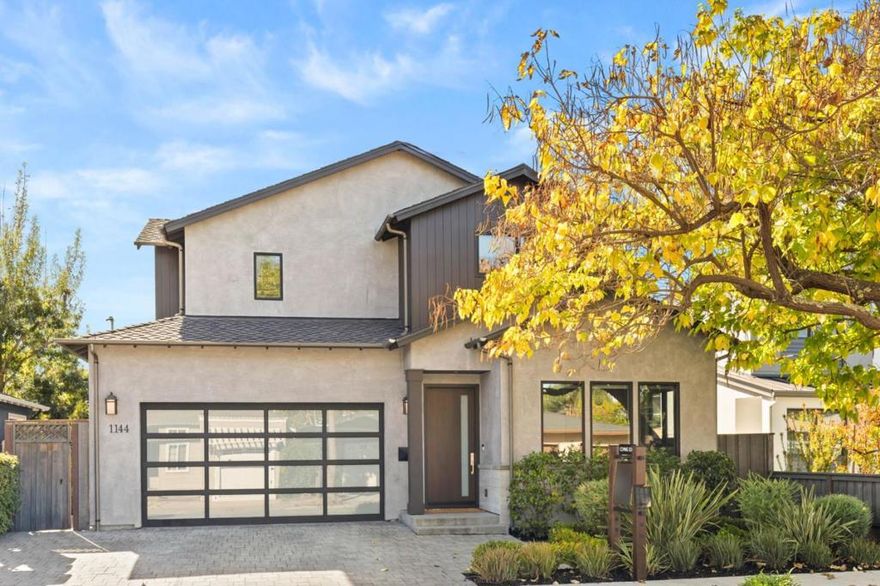 Modern design, impeccable craftsmanship, and curated finishes define this exceptional 2020 home in a premier neighborhood just one block from Red Morton Park. Every detail reflects designer quality, from tongue and groove wood paneling and artfully selected stone and tile to custom lighting and vanities. The open-concept great room centers on a striking feature wall with gas fireplace and extends through sliding glass doors to a covered patio, built-in barbecue, and spacious rear yard. A stunning kitchen with large island seating, butlers pantry, entertainment bar, and formal dining room anchor the main level, which also includes a bedroom suite and separate office. Upstairs are the primary suite with heated floor bath, two additional bedrooms and bath, plus a flexible-use lounge. Additional highlights include white oak floors, air conditioning, large laundry room, and EV charging in the 2-car garage, all just moments from vibrant downtown Redwood City.