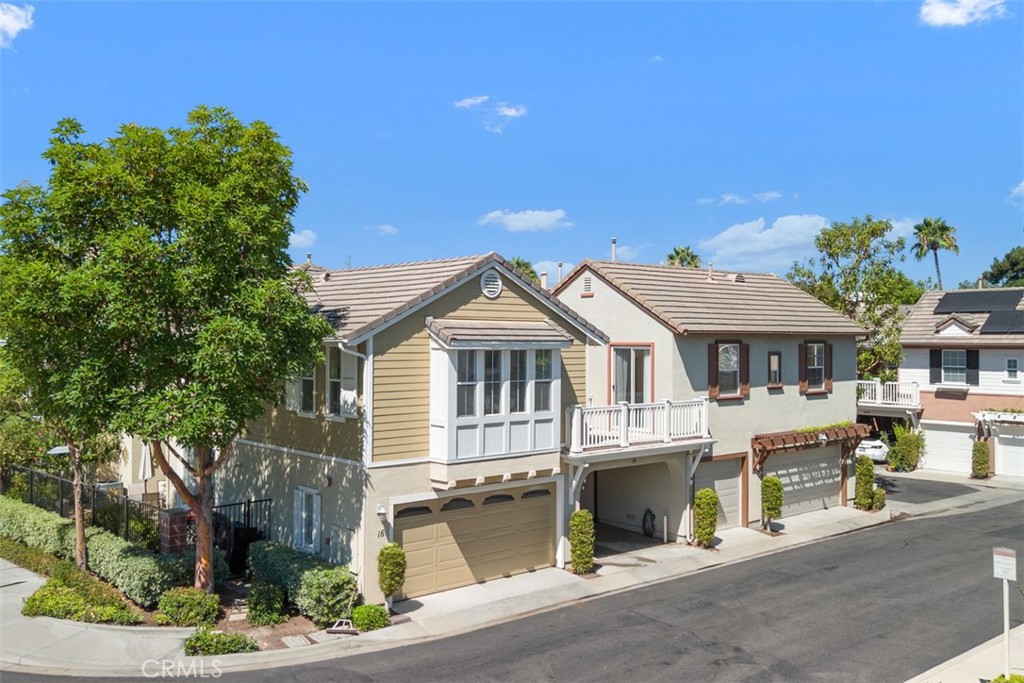 CARRIAGE UNIT w/ SINGLE FAMILY FEEL, NESTED AMONG THE SURROUNDING SINGLE-FAMILY HOMES in Popular "St. Mays Road" Community of Ladera Ranch. This highly sought-after single-level home offers two bedrooms, two full baths, an attached one-car garage, and an additional attached carport conveniently located at the entry. As the end unit, it provides rare privacy on three sides and is tucked away at the rear of the building for a quiet, exclusive setting.
Step inside to a welcoming foyer with extra storage, leading up to a formal entry and wide hallway—perfect for an office niche or reading space. The open floor plan boasts high, vaulted ceilings, abundant natural light from numerous windows, and thoughtful separation between bedrooms and living areas. The spacious kitchen features a center island, built-in desk, and dining area, seamlessly connected to the bright living room. Two sliding doors open to a large private terrace, accessible from both the living room and secondary bedroom, ideal for indoor-outdoor living.
The primary suite offers a walk-in closet, ceiling fan, and en-suite bath with dual vanities.
Recent updates in the home include new Luxury Vinyl Plank (LVP) flooring, fresh interior paint throughout, PEX Re-Piping, creating a turn-key move-in-ready atmosphere.
Enjoy all that Ladera Ranch has to offer; this home is just around the corner from popular Poets Park & Cherry Plunge Pool and Play area. Ladera Ranch not only offers free Gigabit Internet to all it’s residents but also amazing resort-style amenities including pools, clubhouses, parks, picnic areas with BBQs, sports courts, a dog park, and more—all in a vibrant community with top-rated schools.