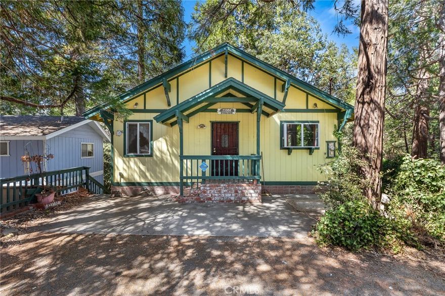 Charming 2 story mountain cabin near Lake Gregory! Vaulted knotty pine ceilings and paneling throughout upper level. Cozy and open main living area complete with brick fireplace. Spacious dining room. Kitchen features tile flooring, great counter space and cabinet storage, breakfast bar and garden window. Dual paned windows throughout. All 3 bedrooms located on lower level. Laundry with washer & dryer. Lots of storage for linens, etc. Separate entry to side stairs from 3rd bedroom. Full bathrooms upstairs and downstairs. Wood deck off of dining/living area. Workshop shed on lower level yard. Level parking and just 3 steps to front door. Conveniently located, close enough to take a stroll into town for shopping and walks around the lake. While this property needs some TLC, its classic features and layout make for a wonderful opportunity to create your vision and restore it to its full charm. Call to schedule a private tour today!