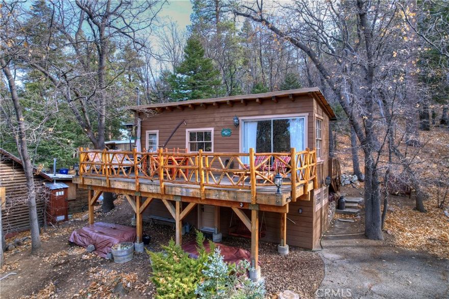 Charming 1-bedroom, 1-bath vintage cabin nestled in a tranquil setting, just a block from the heart of Big Bear Lake Village. This cozy retreat backs up to the serene National Forest, with Towne Trail right in your backyard—perfect for hiking and nature walks. Enjoy a peaceful atmosphere with a wood-burning fireplace and a large deck offering a tree-filled view. Workshop and plenty of storage. The cabin provides year-round access, with multiple parking options at the top, middle, and bottom of the driveway. Located just minutes from the lake, this home combines a private, forested feel with the convenience of being close to all that Big Bear Lake has to offer. Ideal for those seeking a quiet escape or a weekend getaway and like to go jeeping, hiking, snowshoeing, etc.