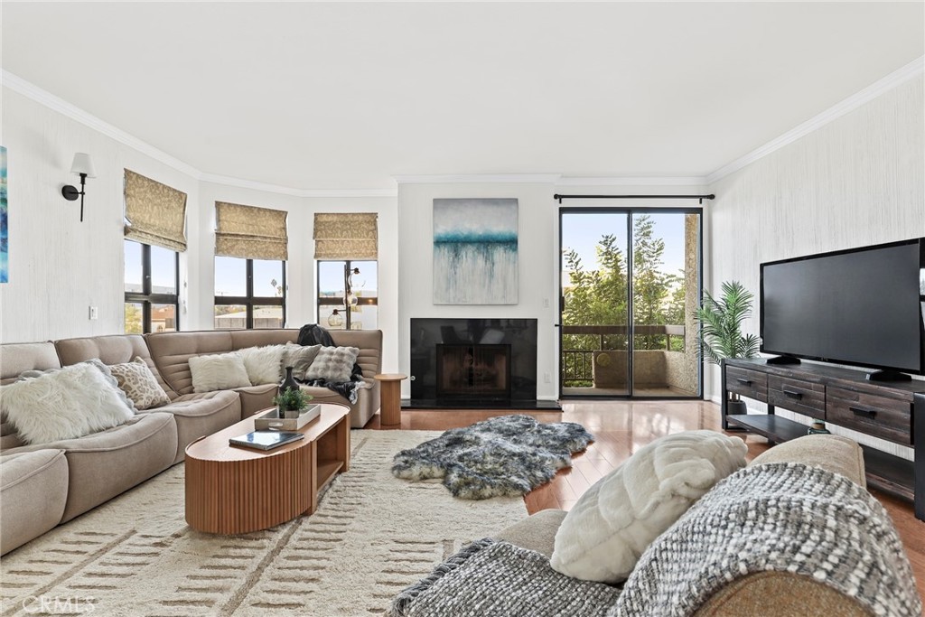 Wonderful Gregory Terrace condo across the street from Beverly Hills. Over 1700+ square feet of living space. Prime location, corner unit with two private balconies and lots of space! Huge, open concept living room with fireplace and wet bar/large dining room and eat in kitchen areas. Wood flooring. BRAND NEW CARPET AND PAINT THROUGHOUT. Two generously sized bedrooms and two full baths including a grand primary suite complete with an ensuite full bath featuring dual vanities and walk in closet. Individual in-unit laundry room with ample storage space. Updated kitchen with granite counter tops, custom cabinets and a walk in pantry. Well maintained smaller building with 18 units, pool, gym and tandem parking (2 spots). Don't miss this amazing opportunity!