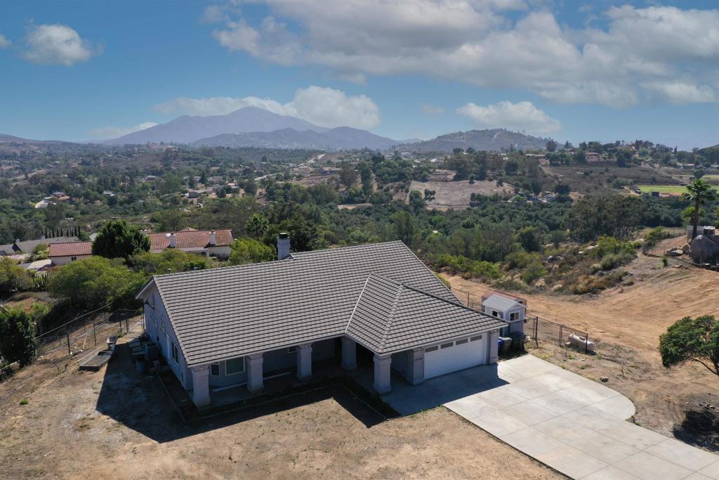 First time on the market! This 2.8-acre Jamul retreat with coastal views offers the perfect blend of peaceful country living and city convenience, located just 10 minutes from shopping, dining, and amenities of Rancho San Diego. Tucked away at the end of a private street, this 3-bedroom, 2.5-bathroom home spans 2,310 square feet of light-filled, thoughtfully designed space. The open floor plan welcomes you with spacious living areas, a cozy fireplace, and durable vinyl plank flooring throughout. French doors from the living area invite you to step out to the rear patio, where endless views and open skies surround you. The kitchen is both functional and inviting, featuring a kitchen island with integrated cooktop and bar seating, a double oven, walk-in pantry, and seamless flow into the dining and living areas, perfect for hosting gatherings. The spacious primary suite is a tranquil sanctuary with dual closets, dual bathroom vanities, large soaking tub and walk-in shower, and patio access, perfect for morning coffee or quiet evenings under the stars. Each bedroom offers generous space and flexibility. Outside, you’ll find a fully fenced, low-maintenance backyard, along with expansive acreage to roam, relax, or dream big, all set against a backdrop of west-facing coastal views and golden sunsets. This is more than a home; it’s an opportunity to live with space, serenity, and style. Come experience the beauty of Jamul living at its finest.