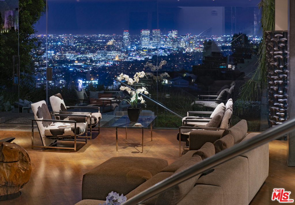 1778 is the crown of Viewmont North, the only gated community in Sunset Plaza. Sited at the end of a cul-de-sac and in over 6,300 sqft, its the largest of only six homes behind the gate. Of the community, this residence delivers the most privacy, the most parking, and explosive city-to-ocean views from nearly every vantage point in and outside the home. Designed with the California lifestyle in mind, there is seamless access to a zero-edge pool and spa, landscaped grounds, grassy area, and grill. Amenities include long walls of glass, high ceilings, walnut floors, five bedrooms, six bathrooms, a gourmet kitchen, home theater, and a large den with a bar adjacent to the pool and yard. The master suite is adorned with a fireplace, luxurious bath equipped with spa tub, separate shower, plus dual walk-in-closets. All this, only moments from the world-class dining, shopping, and entertainment on the Sunset Strip and in Beverly Hills.
