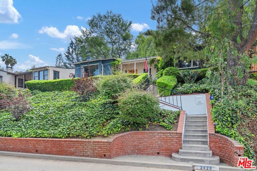 Discover unparalleled privacy and classic charm in this exquisite 2-bedroom, 1.5-bathroom home, perfectly situated on a desirable street-to-street lot. Step onto the welcoming front porch and soak in the serene views, setting the stage for the elegance found within. Hardwood floors flow seamlessly throughout, guiding you through generously proportioned living spaces. The heart of the home features a charming gallery kitchen, thoughtfully designed and complemented by a formal breakfast room ideal for quiet mornings or casual meals. Entertain with grace in the grand formal living room, highlighted by a cozy wood-burning fireplace and picturesque bay windows, offering a perfect blend of comfort and sophistication. A formal dining room awaits your memorable gatherings, ready to host delightful dinners. Beyond the formal areas, a large den provides an expansive haven for recreation and entertainment, offering versatile space for all your needs. The master bedroom and the den offer direct access to a private brick patio, leading to a sprawling rear yard. This tranquil outdoor oasis features a gently sloping hill adorned with lush vegetation, creating a serene and private escape. With its unique street-to-street lot providing ultimate privacy, classic architectural details, and a harmonious blend of indoor and outdoor living, this home is a true gem.