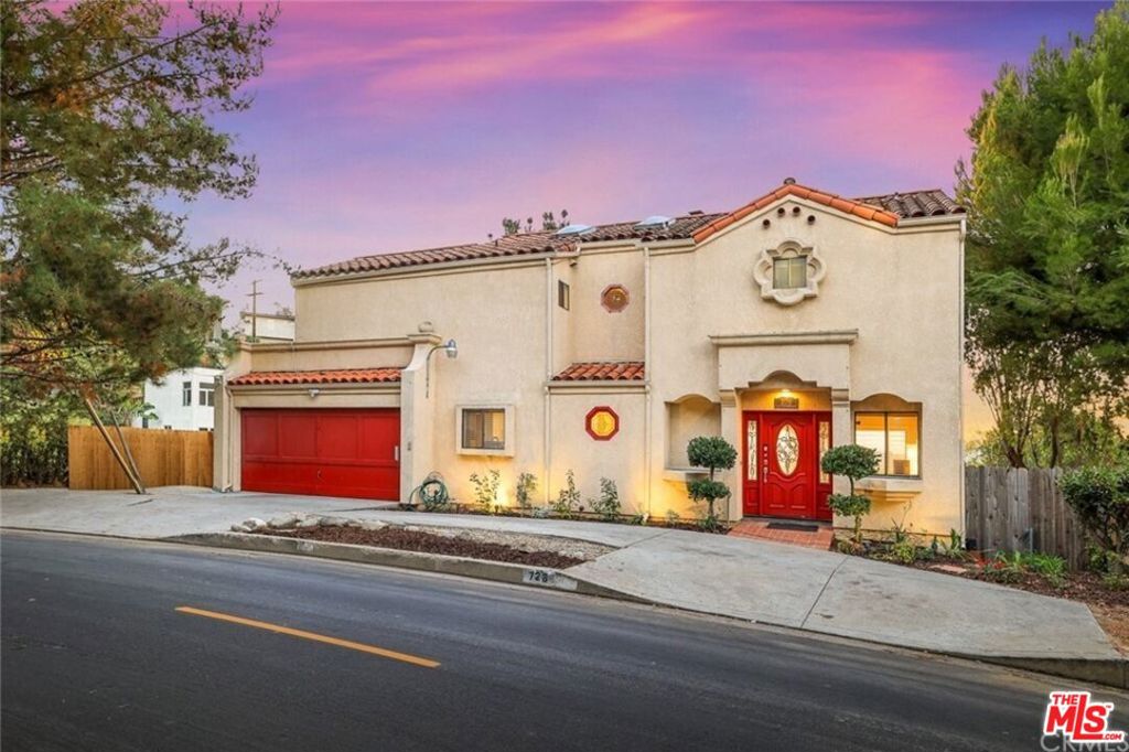 Beautiful 5-bedroom, 4-bath Spanish-style home nestled in the foothills of Montecito Heights! Enjoy sweeping hillside views and an easy walk to Debs Park with its lake and hiking trails overlooking Downtown LA. The home features a circular driveway, 2-car attached garage, and modern interiors with updated kitchen and flooring throughout. The main level offers a spacious living and dining area with a dual fireplace and French doors leading to a balcony facing the stunning Montecito Heights hillside. Upstairs, every bedroom open onto a balcony with serene views. Primary bedroom includes spa stye bathtub, fireplace, and walk-in closet. The lower level provides two large versatile bedrooms, also suited for a huge family/TV room for entertaining or use as a creative studio setup. Lower level includes a spacious tiled bath, and a private office. Additional highlights include updated kitchen, copper plumbing, central HVAC, and abundant closet space. Moments from bustling Figueroa Street's cafes and restaurants, this home combines hillside tranquility with city convenience.