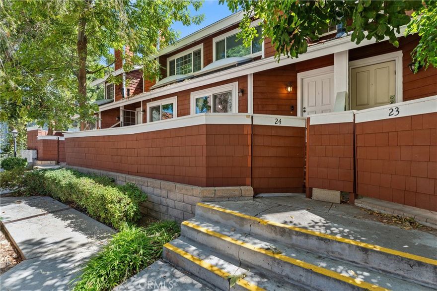 Your Reseda Oasis Awaits! Welcome to this spacious, two-bedroom, two-bathroom unit, offering over 1,000 square feet of comfortable living space in the desirable Country Walk community in Reseda. This unit is not on the main street, providing a quiet, peaceful living environment. Step inside to a home filled with natural light, featuring high ceilings, a spacious living room with a cozy fireplace and a skylight. The freshly painted interior and new flooring create a bright and inviting atmosphere. The newly remodeled bathroom offers modern appeal. The updated kitchen is a cook's delight, with modern stainless steel appliances and lots of counter space. The home offers a great floor plan with good-sized bedrooms and a walk-in closet in the primary bedroom. You'll love the beautiful landscaping and a large front patio that's perfect for relaxing or entertaining. A unique feature is the direct access from the unit to the one-car garage, with an additional assigned parking space right next to it. As a resident, you'll also have access to the community pool, perfect for relaxing on a hot day. *****Seller will consider all offers, including those offers that include Concessions*****