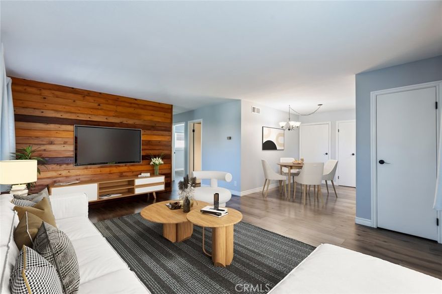 Welcome to Coco Palms! This beautifully remodeled 2-bed, 2-bath condo (approx. 950 sqft per Assessor) blends comfort and style with a warm, inviting atmosphere. A custom wood accent wall sets the tone, while upgrades throughout include new wood laminate flooring, double-paned windows, and modern blinds. The kitchen shines with granite countertops, newer cabinets, sleek hardware, and stainless appliances—including a 5-burner gas stove, dishwasher, and double-door fridge with pull-out freezer—all included. Both bathrooms, including the private primary suite, feature sparkling glass shower/tub doors, framed mirrors, and newer vanities. Bright and spacious bedrooms offer built-in organization systems, while wall AC unit and ceiling fans keep the home comfortable year-round. Step outside to your private patio with a new light fixture and mailbox, perfect for morning coffee or quiet evenings. As an end unit, you’ll enjoy extra privacy in a lush, tropical-inspired community filled with mature trees, plumerias, and bird of paradise. Amenities include a beautifully maintained pool with private baths, BBQ and covered dining areas, and a vibrant lawn space. Whether as your first home, an investment, or a peaceful retreat, this move-in ready condo offers the perfect blend of convenience and relaxation. One covered parking space including storage included and an additional space leased through 2025. Conveniently located between CSU Fullerton and Fullerton College! Fall in love and make it your own!