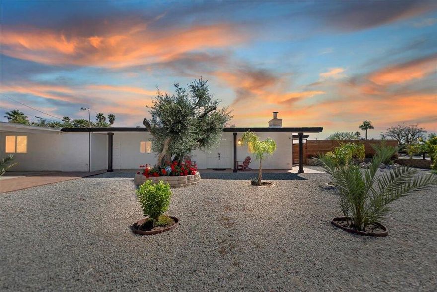 Discover this fantastic mid-century home on a spacious corner lot with a large, covered rear patio and sparkling pool - perfect for enjoying the California sunshine!  Enjoy the convenience of a gated driveway leading to a covered carport, plus generous RV parking.  Inside, you'll find impressive architectural details like soaring 10+ foot ceilings in the entryway and living room and a unique dual fireplace connecting to the cozy family room, showcasing exposed ceiling beams.  The home features stylish wood-like tile flooring, a well-appointed kitchen with granite countertops, a large walk-in pantry, and ceiling fans in every bedroom.  The backyard is an entertainer's dream, offering a refreshing pool and a covered patio ideal for summer gatherings.  This property is perfect for Airbnb! Located just a short drive from the arena, casino, polo grounds (home of the Coachella Music Fest & Stagecoach), various shopping and dining options, and only minutes from downtown Palm Springs, this is a must-see!