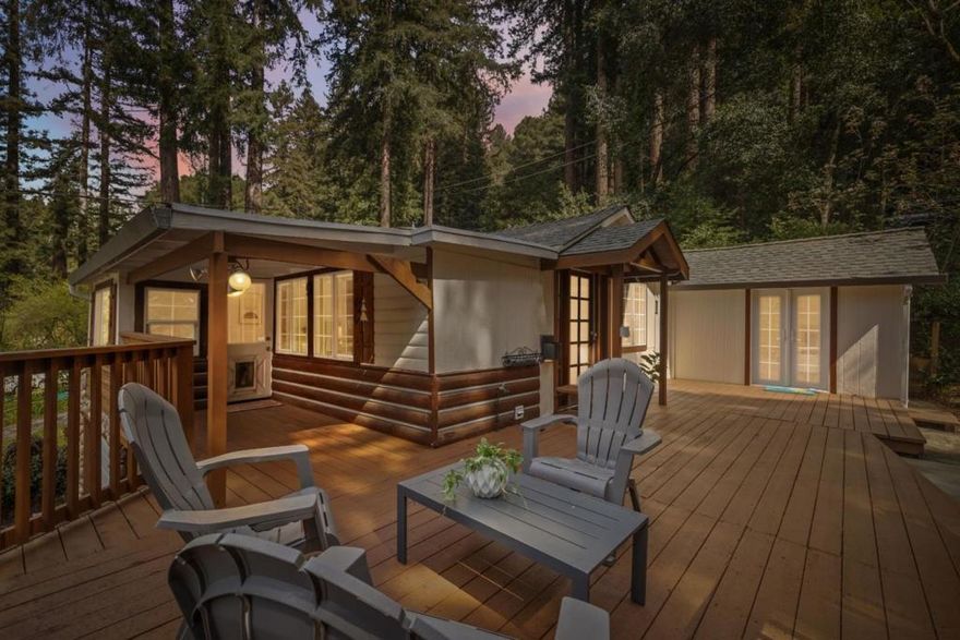 Nestled among the majestic redwoods, this charming 3-bedroom, 1-bathroom home in Boulder Creek blends indoor comfort with outdoor serenity. Expansive windows flood the interior with natural light and frame picturesque forest views, while spacious decking provides the perfect spot to soak up the sunshine during warmer months. Inside, enjoy vaulted ceilings, a cozy fireplace with a stone hearth, and a well-appointed kitchen featuring matching stainless steel appliances ideal for those who love to cook. The primary bedroom serves as a peaceful retreat, complete with French doors that open onto a private deck, perfect for unwinding to the soothing sounds of nature. Conveniently located for Silicon Valley commuters via scenic Highway 9, this home also offers easy access to downtown Boulder Creek's delicious restaurants, hiking and mountain biking trails, and more.