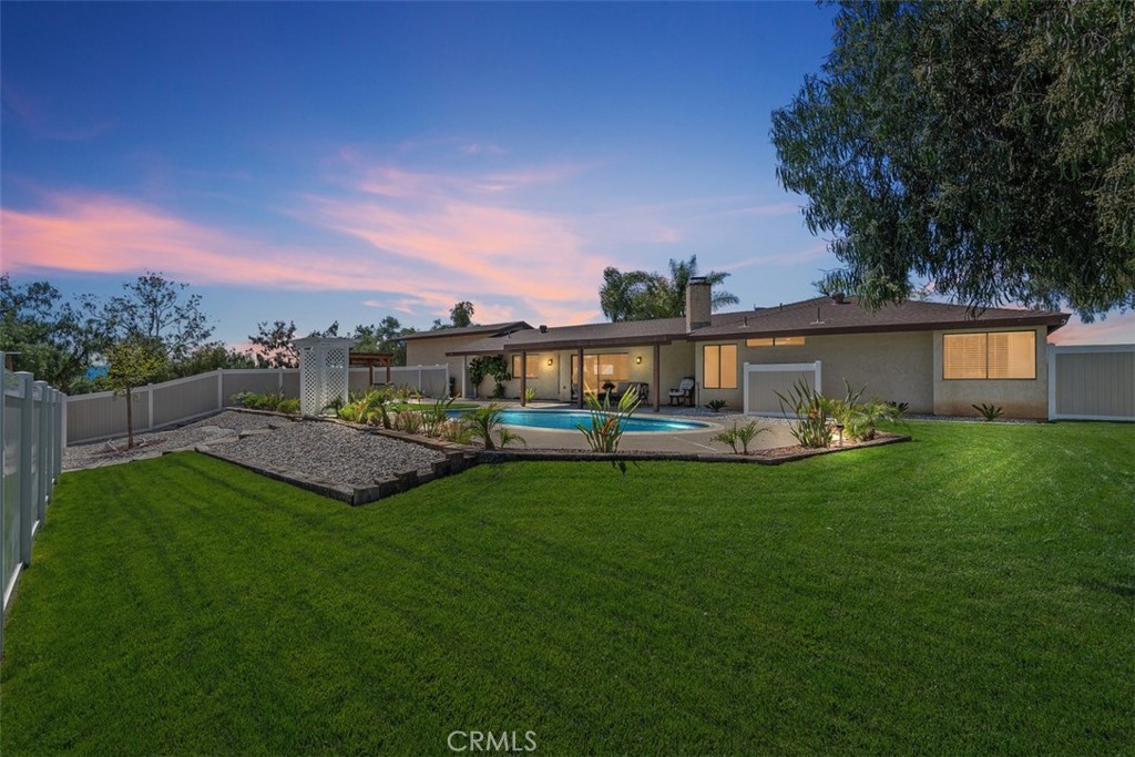 Welcome to this exceptional Murrieta estate—a custom single-story oasis set on 3.26 acres of peaceful, well-maintained land that offers the perfect blend of natural beauty, usable space, and a lifestyle designed for both relaxation and recreation. This meticulously remodeled single-story home offers a harmonious blend of modern luxury and serene country living. The open-concept design is accentuated by a stunning tongue-and-groove wood beam ceiling and a floor to ceiling stone fireplace in the living room that adds warmth and natural beauty to the space, bench window seating, new stainless steel appliances, granite countertops and high-end finishes chosen with impeccable taste. Freshly painted and thoughtfully upgraded, the home features luxury vinyl flooring, soft carpet in the bedrooms, new baseboards throughout. Featuring 3 spacious bedrooms and 2.5 nicely updated bathrooms. The bedrooms are oversized, including a luxurious primary suite with a generous walk-in closet. Both full bathrooms feature double sink vanities. New window coverings are installed throughout the home for a clean, finished look. Step outside to your private backyard paradise, professionally landscaped to perfection. Dive into the sparkling swimming pool, relax under the patio, or cook under the stylish cabana and entertain guests in this idyllic setting. The backyard is beautifully enclosed with vinyl fencing, creating a safe and private outdoor sanctuary. The entire 3.26-acre property is surrounded by secure chain-link fencing, providing peace of mind and space for RVs, boats, trailers, and all your recreational toys. A three-car garage and storage shed add convenience and flexibility. Equestrian enthusiasts will appreciate the riding arena and pipe corrals, offering plenty of room for horses and the potential to expand. A charming seasonal creek meanders through the property, complete with a bridge crossing, and is adorned with mature walnut, pepper, and eucalyptus trees, creating a tranquil and shaded environment. All landscaping is on a water-efficient drip system, including an automatic setup for the yards. Close to parks and located in the highly-rated Murrieta Valley Unified School District. With ADU potential, serviced by a private well with optional city water connection available, no HOA, and close proximity to shopping, restaurants, and hospitals, this Murrieta gem has it all.