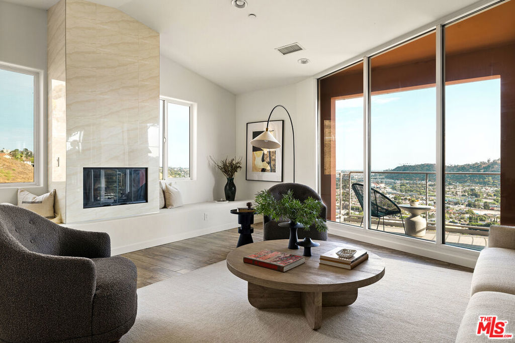 Experience clean lines, contemporary design, and excellent construction from the top of Cliff Drive. Once the French doors swing open, you catch a glimpse from the entryway of the great room, where vaulted ceilings, dramatic angles, and floor to ceiling glass show off truly jaw-dropping views of what feels like the entire city. The handsomely appointed chef's kitchen can accommodate a crowd, includes copious amounts of storage, a commercial sized fridge, and a built-in breakfast bar that gazes over the city below. Upstairs offers plenty of communal and work space, with an office off the kitchen, a 3/4 bath for guests, and a finished two-car garage with additional storage space. Downstairs, the primary suite stuns with a sitting room between the bedroom and spa-inspired bath, as well as access to a private balcony. Three more bedrooms and two more full baths round out the lower level, and a spacious deck down the hill offers a unique setting for al fresco affairs. 1428 Cliff Drive comes alive at night, with unobstructed views from most of the interior, and from each of the home's three balconies. This Mount Washington perch provides close proximity not only to Elyria Canyon Park and the Self-Realization Fellowship but also to the burgeoning strip of Cypress Ave that's home to Barra Santos, The Golden Poppy Market, 1802 Roasters, Loquat, Taqueria Frontera, and more. The sale includes two additional lots (APN#5454008004 and APN#5454008005) for a total of just under half an acre of land. Use that opportunity to build out your dream compound, secure your privacy, or try a little bit of both.