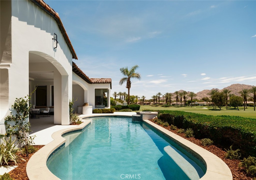 This stunningly renovated home in the exclusive Toscana Country Club showcases breathtaking views of the mountains overlooking the Jack Nicklaus Signature Golf Course. Completely rebuilt and thoughtfully upgraded inside and out, this home features luxurious custom finishes including wide-plank white oak flooring, bespoke white oak cabinetry, Neolith countertops, and designer fixtures. The chef’s kitchen is outfitted with Wolf/Sub-Zero appliances and a walk in pantry. A sleek Enviro linear fireplace adds warmth and modern elegance to the great room. Expansive pocket doors create a seamless indoor-outdoor flow to the private patio, pool, and golf course. A separate guest house offers a private retreat with its own living area, en-suite bath, and kitchenette. This impeccably crafted showpiece is an oasis in the desert and will not disappoint.