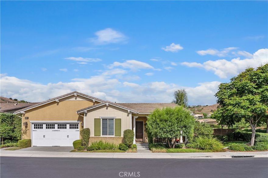 Live your best life in this beautiful single level home! This two bedroom and two bath plus den home is located in the exclusive gated community of Gavilan-Sendero in Rancho Mission Viejo ( 55+ community).  This beautiful home features an open floor plan, chef’s kitchen with top of the line appliances, large kitchen island, exquisite granite counters, wood floors, luxurious primary suite, walk in closet and a large inside laundry room are just a few of the upgrades.  Home is situated on a large corner parcel with views of the hills, picturesque garden and an ever so fun putting green.  Close to “The Hacienda”, this gated clubhouse offers spaces for serious fun and relaxation. HOA amenities include a collection of indoor/outdoor community facilities set around scenic courtyards with panoramic hillside views, sparkling pools, fitness center, pickleball, and bocce play.