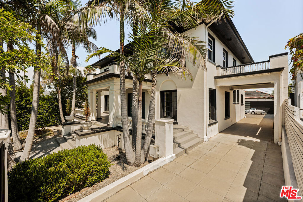 Tucked behind gates in the heart of Los Angeles, 564 Normandie Ave is a rare blend of timeless elegance and contemporary comfort. From the moment you step through the formal entry, you're greeted by classic Old Hollywood detailing--ornate wall moldings, a graceful staircase, and rich textures that evoke a sense of history and charm. The home's airy, light-filled layout invites you to slow down and enjoy each thoughtfully designed space. Large windows flood every room with natural light and frame spectacular views of the Hollywood Sign, Griffith Observatory, and the mountain ridges from the second floor. Each room feels expansive and intentional, with high ceilings and functional layout that enhances the historic detailing throughout. The bedrooms are especially generous, offering quiet retreats bathed in light. Original charm is preserved, while tasteful updates add just the right amount of modern polish. Outdoors, the magic continues. The oversized backyard is completely private--ideal for entertaining, relaxing, or soaking in the sun by the sparkling pool. Lush landscaping, mature trees, and a detached garage enhance the functionality and appeal of this stunning property. Secure, spacious, and filled with timeless character, this home is a unique offering in one of LA's most desirable locations. Whether you're drawn to its cinematic charm, the breathtaking views, or the sense of quiet retreat, 564 Normandie Ave offers a lifestyle that feels both luxurious and grounded.