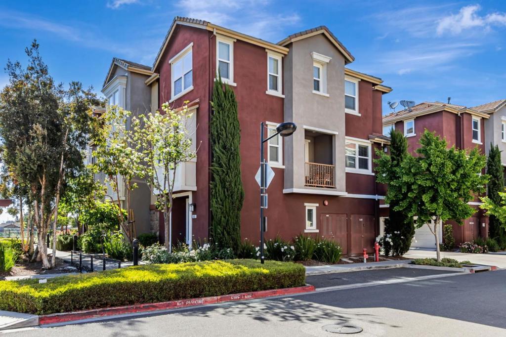 No neighbor above, below, or in front! This modern townhome is situated in the highly sought-after Avenue Community, offering an ideal location with stunning mountain views and an exclusive sense of privacy. It features a side-by-side two-car garage with plenty of storage space. The home is designed with a modern and elegant flair, showcasing an open-concept layout with high ceilings. The gourmet kitchen includes granite countertops, a large island, stainless steel appliances, contemporary cabinetry, and recessed lighting. Beautiful flooring runs throughout the entire home, except for the staircase, which adds a unique touch. Freshly painted, it offers dual-zone central A/C and heating, a tankless water heater, and a private patio. The low HOA fees cover numerous amenities, trash removal, common area insurance, multiple playgrounds, and lush greenbelt areas. This home is conveniently located within walking distance of the Milpitas BART station, the new Mattos Elementary School, shopping centers, and the Great Mall. It also provides easy access to public transportation, freeways, and major high-tech companies, with no rental restrictions. This home wont last long!