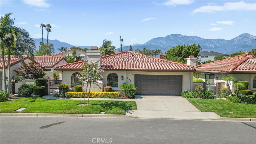Welcome to Villa Montelena, one of Upland’s most sought-after gated communities, known for its serene setting, manicured greenbelts, and resort-style amenities. This beautifully maintained single-story home offers 2,277 square feet of thoughtfully designed living space with 3 spacious bedrooms and 2 full bathrooms—all with no interior step-downs.
Inside, you’ll find a generous layout featuring a formal dining room, spacious living room, and a separate family room—ideal for entertaining or everyday living. Thoughtful design details such as a coffered foyer ceiling, crown molding, substantial baseboards, and a combination of custom window coverings and plantation shutters elevate the home’s interior with refined style. The updated kitchen offers granite counters, abundant cabinetry with pull out shelving, quality finishes, and overlooks the backyard greenery.
The private primary suite is a true retreat with a soaking tub, separate walk-in shower, dual-sink vanity, and a large walk-in closet. The two additional bedrooms share a dual-sink Jack-and-Jill style bath, and both feature mirrored wardrobe doors—one with direct access to a peaceful interior courtyard. A dedicated indoor laundry room with extra storage adds everyday convenience.
Enjoy a beautifully landscaped backyard with mature citrus trees and vibrant flowering plants, creating a peaceful setting for outdoor relaxation or entertaining. The front yard is maintained by the HOA, offering low-maintenance living and consistent curb appeal in this well-cared-for private community. Ideally positioned in a prime interior location with north/south exposure, this home is nestled between the community’s two pools, spas, and tennis courts with pickleball, all surrounded by lush greenbelts and scenic mountain views. The attached two-car garage features built-in storage, steel shelving, and a workbench for added functionality.
Residents of Villa Montelena enjoy resort-style amenities and beautifully landscaped grounds. The neighborhood offers close proximity to The Colonies, Upland Hills Country Club, nearby parks, schools, and dining, with easy access to Downtown Upland, the Claremont Village, and the 210 freeway—making this location as convenient as it is desirable. Single-story homes like this are a rare find—schedule your private showing today.