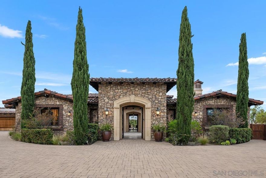 Nestled within the exclusive, guard-gated Santaluz community, this Tuscan Farmhouse redefines luxury living. Built in 2014 with craftsmanship and the highest quality materials, this impressive single-level estate seamlessly blends old-world charm with modern elegance and smart home technology.  Designed for both everyday relaxation and grand entertaining, the residence features a beautiful great room, an additional family/flex room, a gourmet chef's kitchen, an in-home office, a casita, three guest suites, and a five-star primary retreat. The beauty of this estate extends beyond its exquisite aesthetics; it was meticulously constructed to exceed the highest earthquake and structural standards, stone retaining walls, a structural steel I-beam (spanning the formal great room), conventional framing, and a stone exterior.  The beautifully designed, resort-inspired saltwater swimming pool and spa are perfect for enjoyment and entertaining. The pool area includes an oversized 18” deep sun shelf with two in-pool umbrella stands for shade, and a 60-foot lap and play pool with an infinity edge overlooking the protected rimmed canyon. The entire pool system is operated by top-rated equipment and smart-controlled functionality. Completing the outdoor oasis is an outdoor kitchen with a BBQ, warming drawer, and mini-fridge.  Living in Santaluz offers an unparalleled lifestyle. This upscale, 24/7 guard gated community provides residents with a wealth of world-class amenities and a strong sense of community.  Smart Home Technology & Systems Integrated Crestron System: Effortlessly control audio, video, and security systems throughout the entire home and outdoor spaces using wireless smart devices or in-wall master control panels in the kitchen and master retreat. Whole Home Security: Features a comprehensive security system  Lutron (Vantage) Lighting System: Customize lighting moods and scenes throughout the property with "one-touch" control or manage each room independently.  HVAC System: Integrated with Nest and a whole-home electronic HVAC ventilation system, featuring three separate furnaces/condensers. Control the entire system or individual rooms with a smart device or in-wall units for optimized comfort and energy efficiency.  Plumbing System: Three independent tankless water heating systems with pumps for hot water. The home features a full home water filtration system, while a secondary kitchen system provides purified drinking water and instant hot water. The Chef's Kitchen is a true culinary dream, perfect for daily living and entertaining: Wolf 60” range with double ovens, 6 burners, and a large griddle, warming drawer, steam oven, and microwave. Sub-Zero dual 48” refrigerator and freezer, under-counter wine fridge. Two Bosch dishwashers. Thermador Latte/Coffee/Espresso bar. Massive prep and eat-in island with granite slab countertops and double DuPont edges, custom cabinetry, large butler's pantry with an oversized walk-in pantry, wired for a second fridge/freezer.  Luxurious Finishes & Features: Flooring: Marbol stone floors throughout the great room, kitchen, formal great room, and main hallways. Hardwood floors in the master retreat, master bonus/office/nursery, and executive office. Carpet with dual pad in all secondary bedrooms and the casita. Tumbled travertine on all floors and walls in baths.  Stone Wall Finishes: Volcanic Venetian Stone from Cappadocia, Turkey, used throughout, including a hand-chiseled Venetian Stone fireplace mantel in the formal great room. Tuscan brick accents throughout the home. All exterior elevations and walls clad in Eldorado Stone, Tuscan Brick, and forged Capstone.  Master Bath: Appointed like a five-star resort spa, featuring his-and-her toilets (plus bidet for her), 2 walk-in closets, dual sinks with vanity, a 72x42 air-jet relaxation tub, and a huge walk-in steam/jetted/rain shower.  Resort-Style Outdoor Living: The beautifully designed, resort-inspired saltwater swimming pool and spa a...