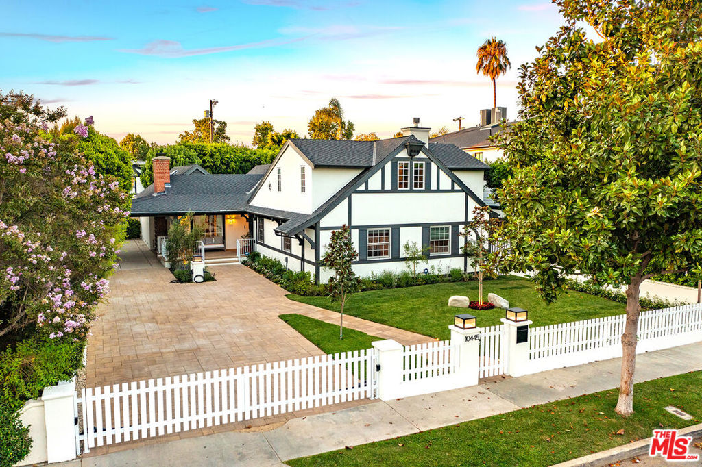 This is the one Toluca Lake has been waiting for! Located on a beautiful tree-lined street, steps from the Toluca Estates & minutes from the private golf club, this home is sure to go quickly. This stunning 5 bedroom, 4 bathroom, 2-story residence offers 4,098 sq ft of living space (including the garage and studio above) on a generous 10,802 sq ft lot. Recently updated with gorgeous new landscaping, a new security gate, 2 electric car chargers, hedging for privacy, and renovated bathrooms and kitchen, it is truly move-in ready. As you enter, you are welcomed by a grand living room featuring a coved ceiling with recessed lighting, wood floors, a built-in bookcase, fireplace, and a large picture window revealing the yard's lush greenery.Off the living room, the newly updated chef's kitchen boasts beautiful natural light all day, custom cabinetry, crisp white quartz countertops and backsplash, brand new appliances, and a cozy breakfast room with French doors to the yard. The adjacent formal dining room overlooks the landscaped yard and pool, creating a relaxed yet elegant setting for holidays, dinner parties, and entertaining. Off the dining room, a full wet bar featuring a brand new wine fridge and matching quartz countertop leads into a light-filled bonus room enclosed in windows, perfect as a lounge or study, with double French doors opening to the yard. Downstairs also includes (3) generously sized bedrooms, (2) bathrooms, and a mudroom/laundry room. Upstairs, the expansive primary suite includes a walk-in closet and an updated bathroom with a quartz double vanity, stand alone tub, and a shower, perfect sanctuary for peace and relaxation. The front yard features a new security gate, fresh landscaping, and cement pavers lined with landscape lighting for nighttime ambiance. The private backyard is perfectly manicured, with a large pool & jacuzzi. Above the two-car garage is a permitted bonus room with the fifth bedroom and bathroom, ideal for guests or housekeeping quarters. Call or text LA1 or LA2 for all showings and more information!