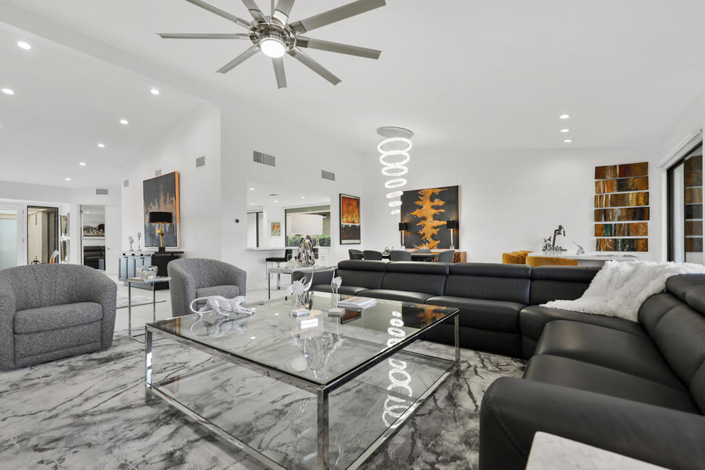 Experience the pinnacle of luxury living in this fully remodeled, contemporary 4-bedroom, 4.5-bathroom masterpiece in the heart of Indian Wells. This stunning property includes a fully paid-off 22-panel solar system, offering unmatched comfort, style, and sustainability. Enter through a private courtyard into an expansive 3,307 sq ft open-concept design, perfect for intimate gatherings and grand entertaining. The home boasts exquisite white porcelain tile, soaring cathedral ceilings, and abundant natural light, creating a sophisticated and inviting ambiance.The primary suite is a sanctuary with an impressive walk-in shower, dual vanities with matching stone finishes, a spacious walk-in closet, and patio access. Each additional bedroom offers en-suite baths, walk-in closets, and ample space. A beautifully appointed powder room completes the interior. The outdoor living space is a true haven, featuring breathtaking fairway views, stunning sunsets, a fire pit, a bar area, and new pavers surrounding the property. Perfect for relaxation or entertaining, the back patio seamlessly blends style and comfort. Eco-conscious amenities include an electric vehicle charging outlet in the 2-car garage, golf cart access, and a solar system for energy efficiency. This fully furnished, turnkey home nestled in one of the desert's most sought-after communities. Don't miss this exceptional opportunity. Schedule your private showing today.