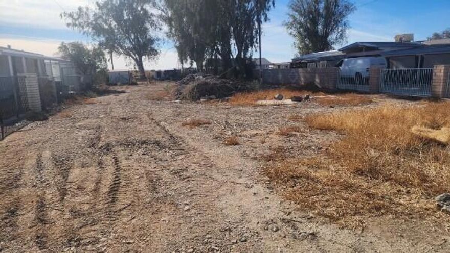 Don't miss this rare opportunity to own a stunning, large lot in Blythe--one of the few fee land properties available! Just minutes from town and steps from the Colorado River, this property offers incredible potential for your dream home or a multi-family setup. Whether you want to build a custom residence or place a manufactured home, this expansive lot provides endless possibilities.Located in a charming, tight-knit neighborhood, longtime residents enjoy a true small-town atmosphere. Perfect for families, retirement living, or even an Airbnb, this lot is walking distance to the river in both directions and nestled between two popular recreational parks. To the north is Hidden Beaches Resort, an RV resort offering essentials for water adventures. To the south is Mayflower County Park, featuring a brand-new boat ramp, day-use areas, RV accommodations, BBQ grills, and friendly staff to enhance your outdoor experience.The property includes its own water well (in need of minor repairs), electricity, and natural gas, with municipal water expected to extend to the area soon. Towering eucalyptus trees add natural beauty and shade, while the west-facing back of the lot offers breathtaking, unobstructed sunset views--an ideal retreat to unwind each evening.Don't let this once-in-a-lifetime opportunity slip away. Schedule your visit today and imagine the possibilities!