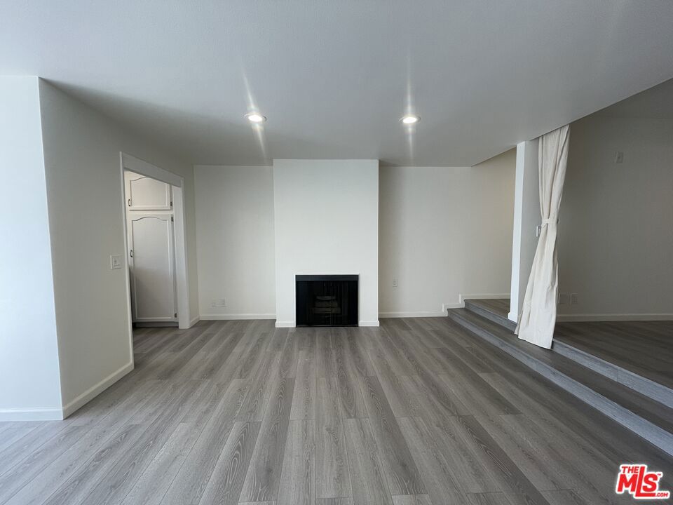 Located on a quiet street in a small, controlled-access building, this oversized junior 1-bedroom unit is situated on the top floor and faces the street. The unit features a large private balcony, new hard surface flooring, updated kitchen appliances, a gas fireplace, and a built-in wet bar.Additional highlights include a spacious walk-in closet, an oversized bathroom vanity, and ample storage throughout. One reserved parking space is included in the gated underground garage. Water and trash are paid by the landlord.