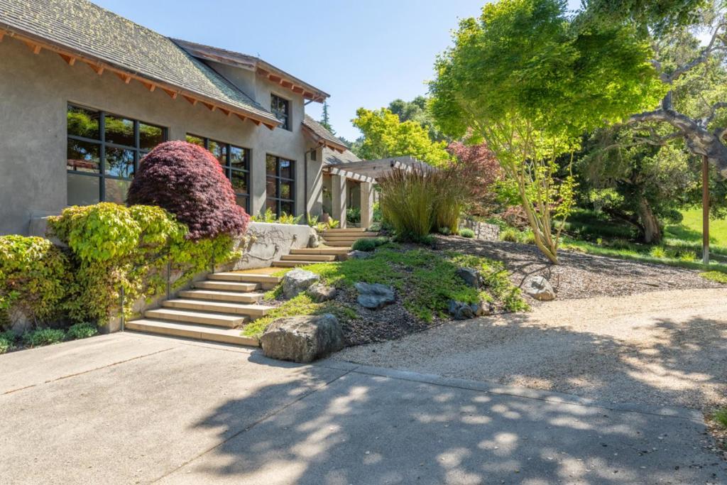 Discover this stunning custom-built home nestled on a sprawling 3.5-acre lot in Quail Meadows, perfectly embodying the California indoor/outdoor lifestyle. Property features rustic open-beam ceilings and hand-scraped walnut floors, beautifully complemented by modern Fleetwood sliding doors and windows. Designed for climate efficiency, with 8-inch foam-filled plaster walls, integral-color plaster interiors, and elegant finishes such as vertical grain white oak cabinetry and concrete counters. A separate 1 bedroom, 1 bath guest cottage mirrors the main house's exquisite design. The main residence includes a luxurious primary suite, spacious great room, chefs kitchen, office and a versatile loft or hobby room. Additional amenities include radiant heating, wine cellar, elevator, 4 fireplaces, central vacuum and AV system. Lush gardens, complete with a spa and waterfall are serviced by a well with a 10,000-gallon storage tank, adding to the property's self-sufficiency. This exceptional home offers unparalleled comfort and elegance, making it an ideal retreat for both relaxation and entertaining.